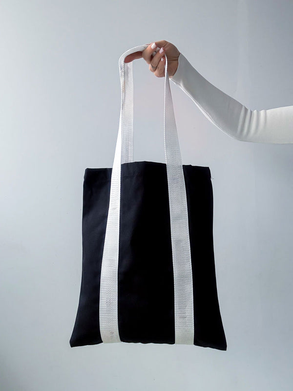 Large twill shopper tote bag with sewn-on white ribbons along the length