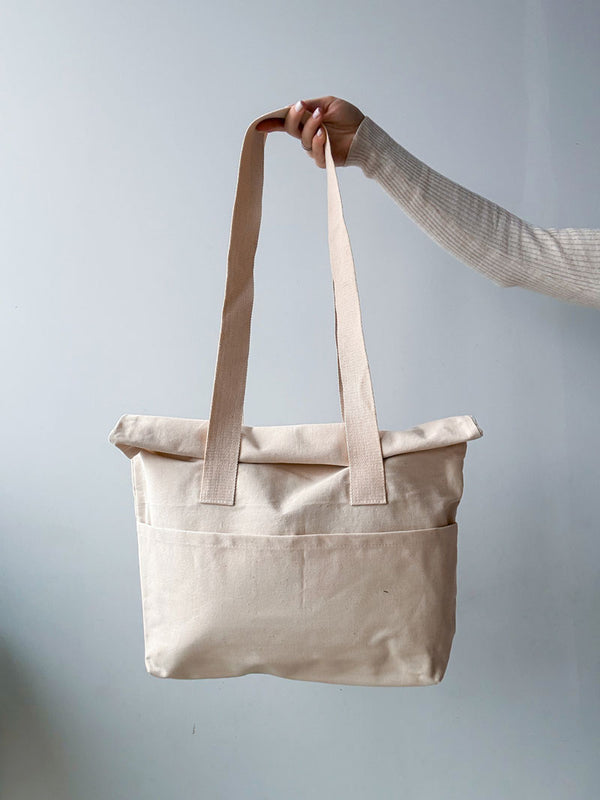 Spacious tote bag with sturdy handles and roll-up top for convenience
